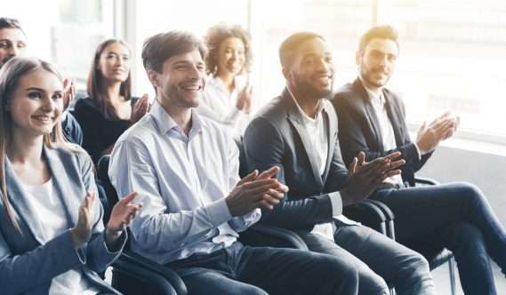A group of people clapping.